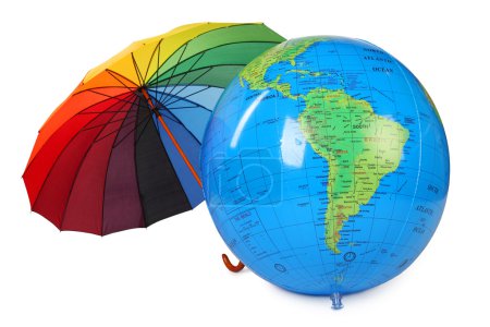 Big inflatable globe and colored umbrella isolated on white back