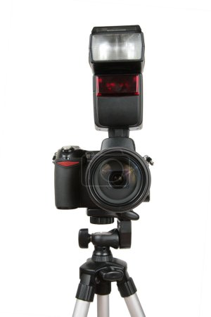 Modern photo camera with flash on tripod