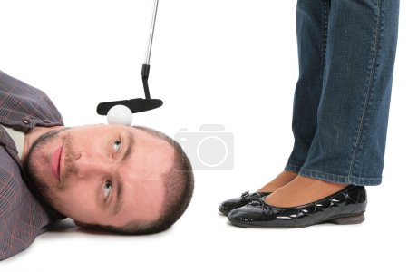 Ball for golf lies on an ear at the man