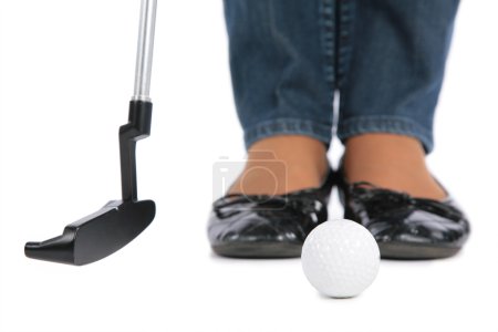 Feet, stick and ball for golf