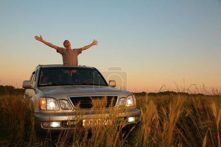 Man with offroad car in field