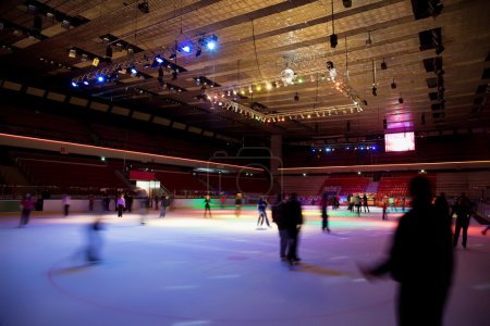 Big covered skating rink with multi-coloured illumination in spo