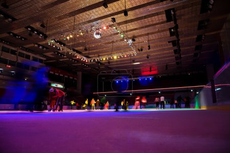 Big covered skating rink with multi-coloured illumination in spo
