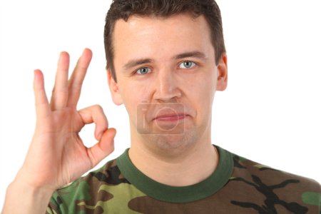 Man in camouflage shows gesture ok