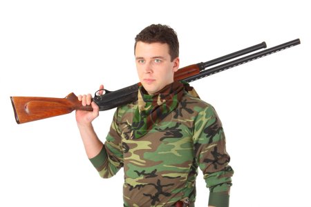Man in camouflage with gun on shoulder