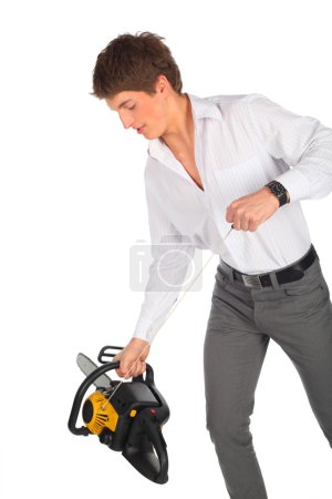 Young man starts chainsaw