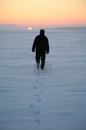 Man goes through the snowy field 2