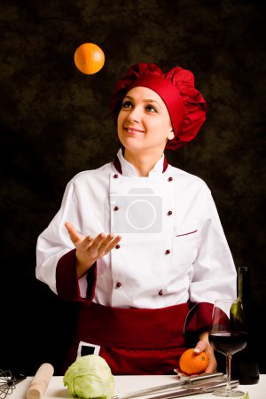 Chef juggling with orange