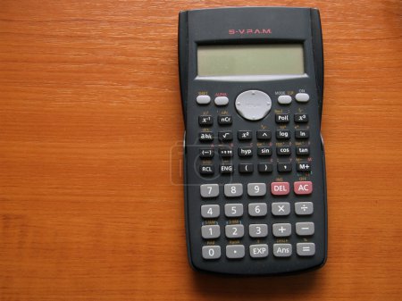 Scientific calculator on the brown table