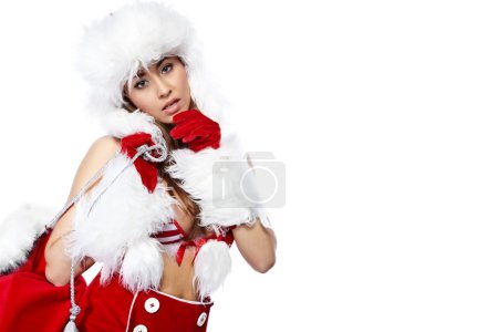 Studio portrait of a sexy young brunette woman dressed as Santa