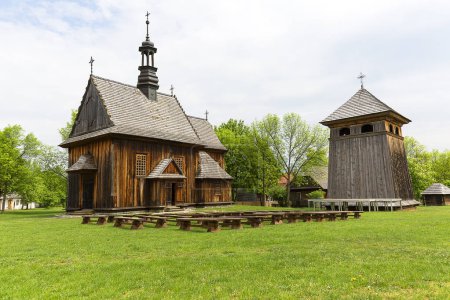 TOKARNIA, POLAND - MAY 2, 2018: 18th century wooden church in open air museum, Museum of the Kielce Village ( Muzeum Wsi Kieleckiej),  rural landscape