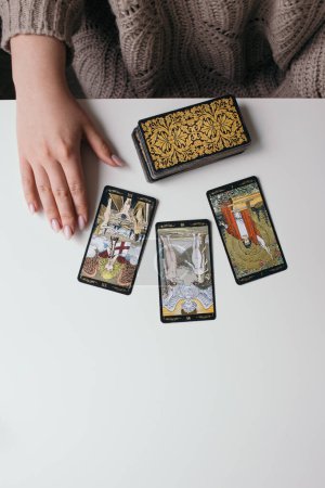 woman with tarot cards in hands