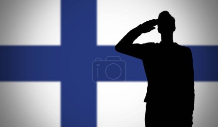 Silhouette of a soldier saluting against the finland flag