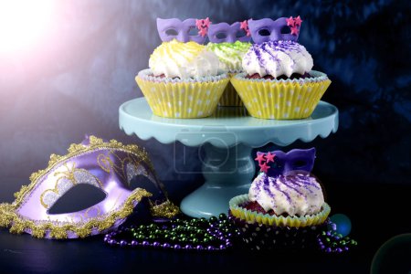 Mardi Gras Cupcakes with face mask decorations, with lens flare.