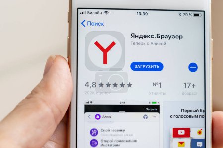 MOSCOW, RUSSIA - JANUARY 08, 2018: Hand holding Apple Iphone 7s with Yandex Browser application downloading from app store on the screen.