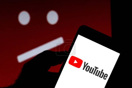 April 5, 2019, Brazil. YouTube logo on your mobile device. Sad YouTube on background. Application is a video sharing platform.
