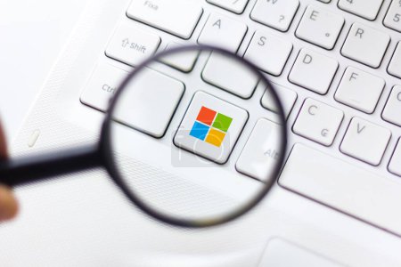 October 3, 2019, Brazil. In this photo illustration the Microsoft Windows logo is displayed through a magnifying glass