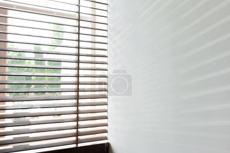 Wooden blinds with sun light in a house room