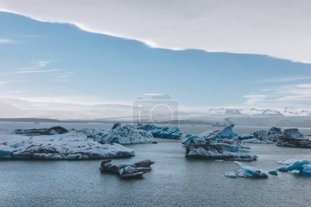 scenic shot of glacier ice pieces floating in lake in Jokulsarlon, Iceland