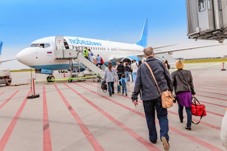 HALLE AIRPORT, GERMANY - MAY 23, 2018: Boarding on POBEDA airlines Russian lowcost Jet airplane in airport