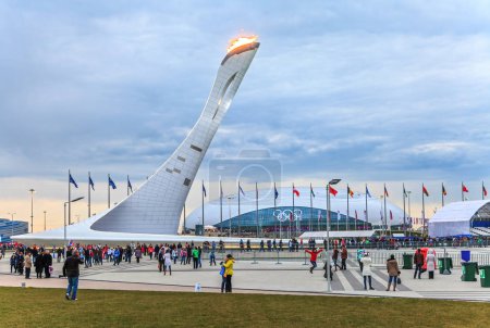 Sochi, Russia - February 15, 2014: Huge Olympic Torch erection with burning flame in Olympic Park was main venue of Sochi Winter Olympics in 2014. Beautiful scenic landscape.