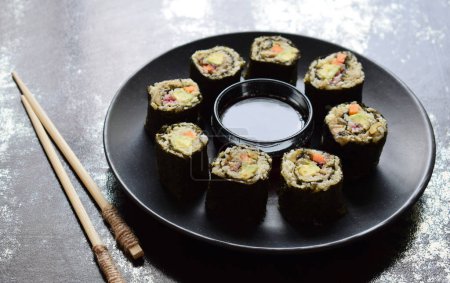 Sushi from cauliflower, avocado, tuna and carrots. Traditional Asian food. Diet healthy food concept. Cereals free. Gluten free. Dairy free. AIP Autoimmune Paleo. Copy space for text