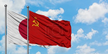 Japan and Soviet Union flag waving in the wind against white cloudy blue sky together. Diplomacy concept, international relations.