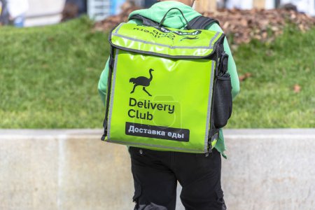MOSCOW - JUL 10: Delivery Club Worker with branded Backpack in Moscow on July 10. 2019 in Russia. Delivery Club is a mobile and desktop platform for food delivery