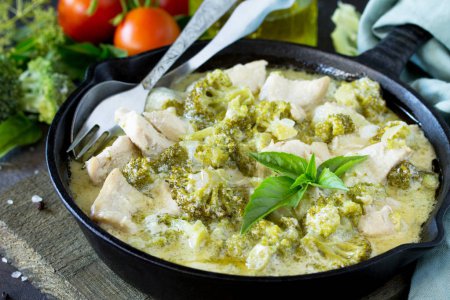 Healthy food: Chicken Stew with Broccoli and Sour Cream on a stone or slate background, close-up. Diet menu.