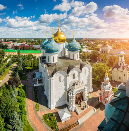 View of the Assumption Cathedral and the Nadkladeznaya Lavra chapel in Sergiev Posad from the height of the bell tower on a summer sunny day