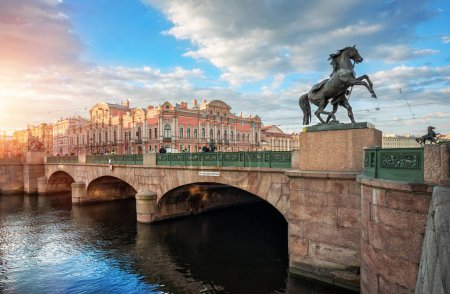 Anichkov Bridge in St. Petersburg with sculptures of horses and a sunny summer morning.  Inscription on the bridge: Passage of ships is prohibited.
