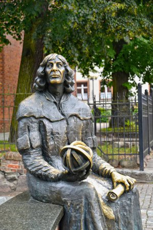OLSZTYN, POLAND - AUGUST 26, 2018: A fragment of a monument to Nicolaus Copernicus with an astrolabe and the manuscript in hands