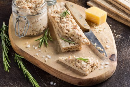 Tuna pate with egg, cheese in a jar and crispy bread. Fish rillette, healthy snack, diet food