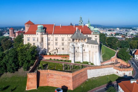 Historic royal Wawel castle and cathedral in Krakow, Poland, with defensive walls and a garden. Aerial view in the morning.