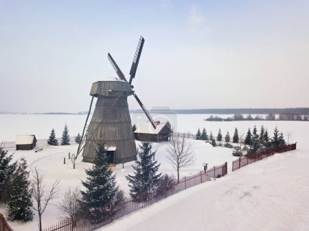 Authentic wooden windmill at winter season. Aerial view of landmark Dudutki in Belarus