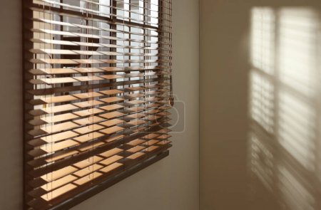 Window with horizontal blinds in room. Space for text