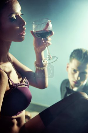 Sexy nude woman with glass of wine