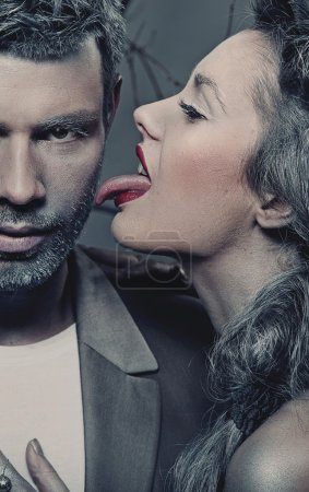 Woman licking man's cheek