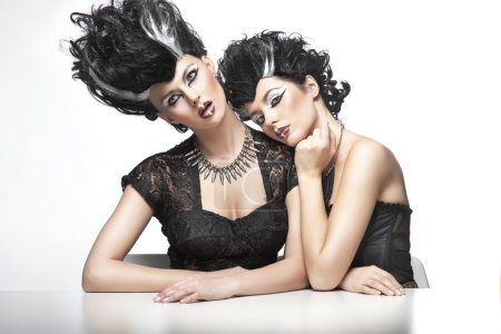 Two sexy women wearning wigs