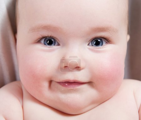 Close-up portrait of sweet little smiling baby girl