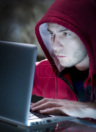 Hacker. Man With Computer In A Dark Room