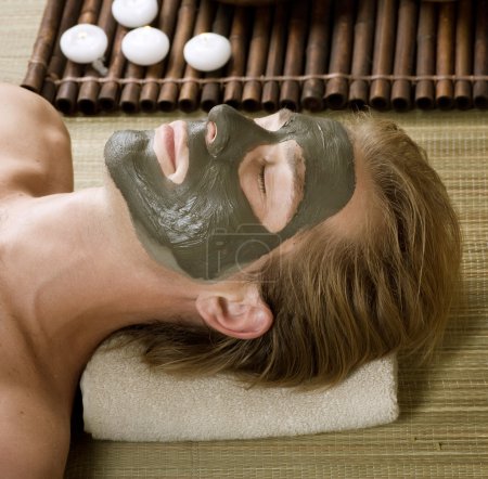 Spa. Handsome Man with a Mud Mask on his Face