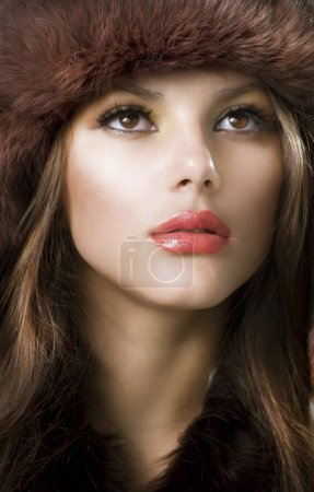 Beautiful Young Woman wearing Fur Hat.Winter Style