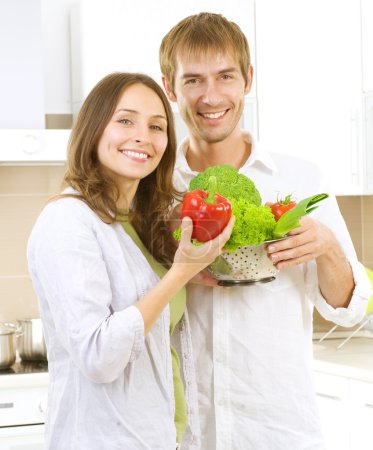 Young Couple Cooking Healthy food.Diet.Kitchen