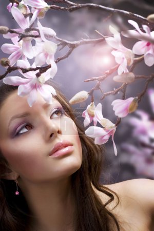 Beautiful healthy young Woman with spring flowers