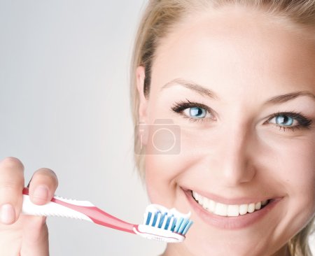 Happy Young Woman Brushing Her Teeth
