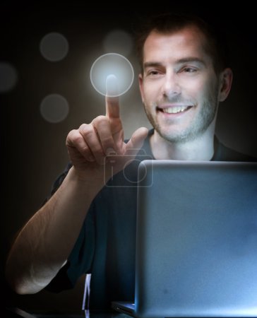 Young Man With Laptop Pushing The Button