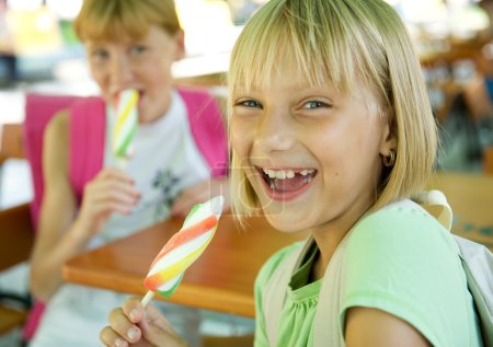Happy Schoolgirls Eating Ice Cream