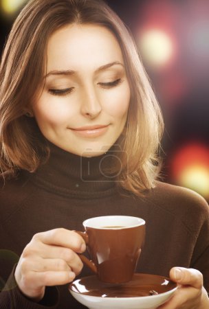 Beautiful Young Woman drinking Coffee