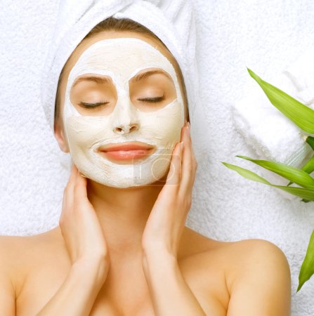 Spa Woman applying Facial clay Mask. Beauty Treatments